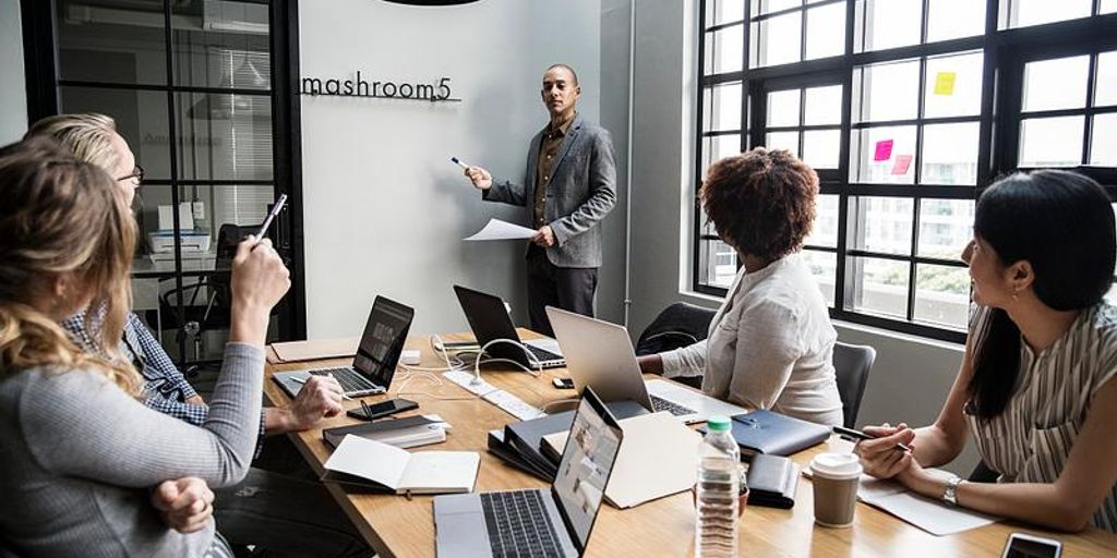 modern office with diverse team using technology