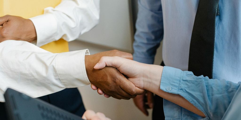 business partners shaking hands in a modern office