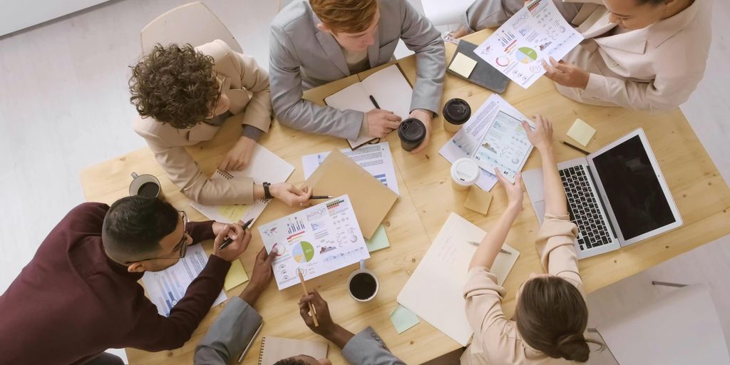 group of diverse business leaders discussing strategy in a modern office
